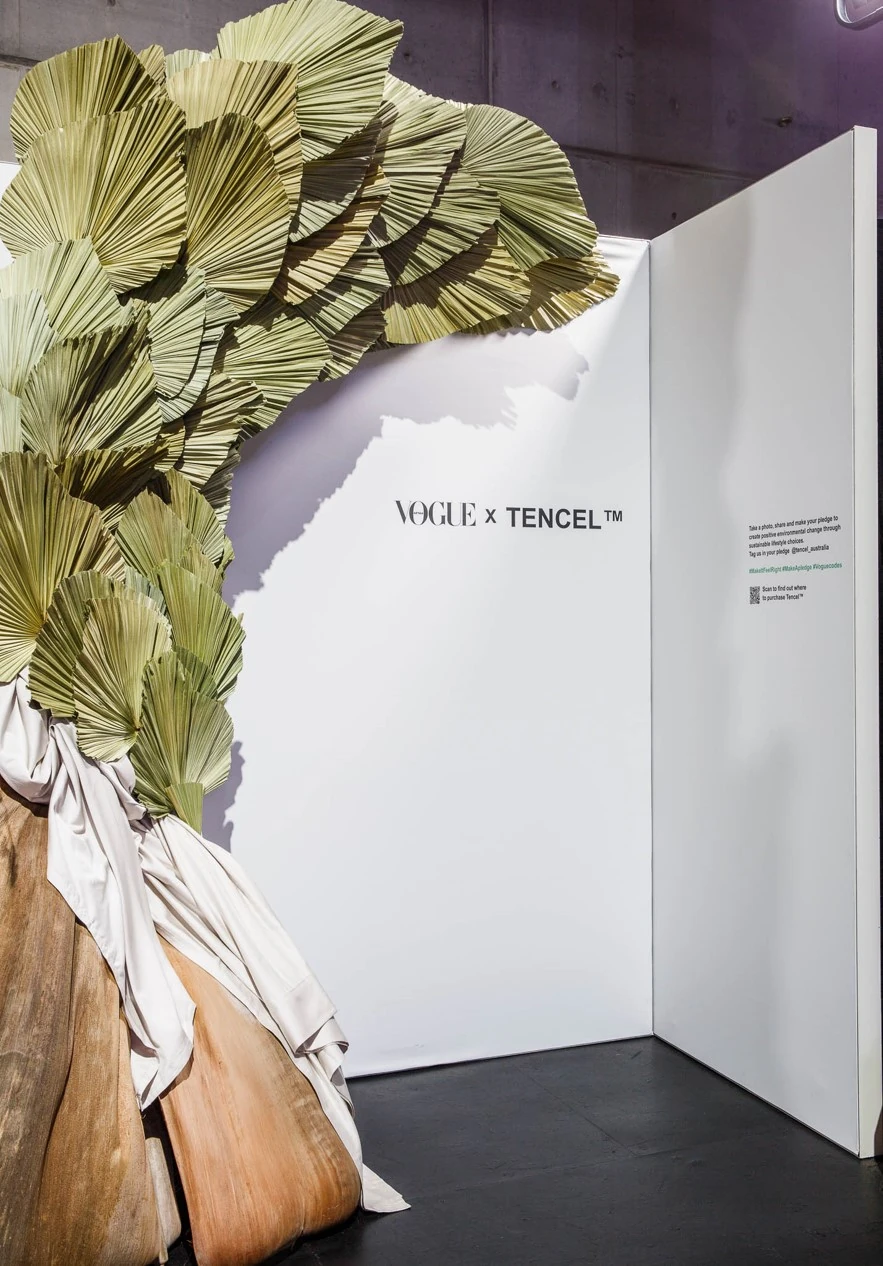 Vogue x Tencel exhibition booth with dried palm frond installation